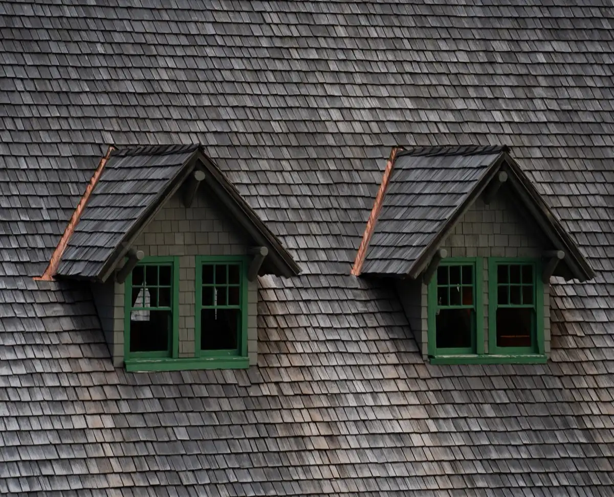 Dormers on a shingle roof in Escondido, CA, where step flashing and kickout flashing carry water past the walls
